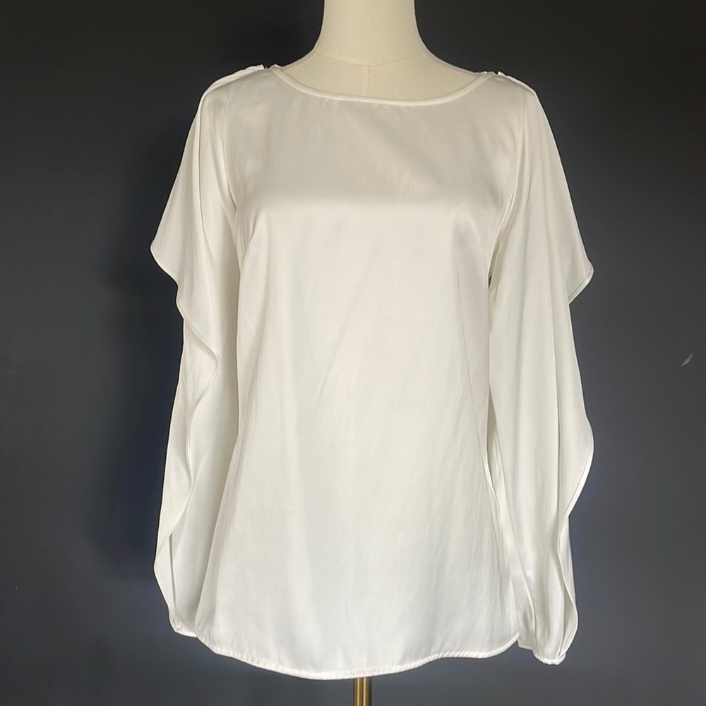 Flared shoulder satin blouse with exposed shoulders.